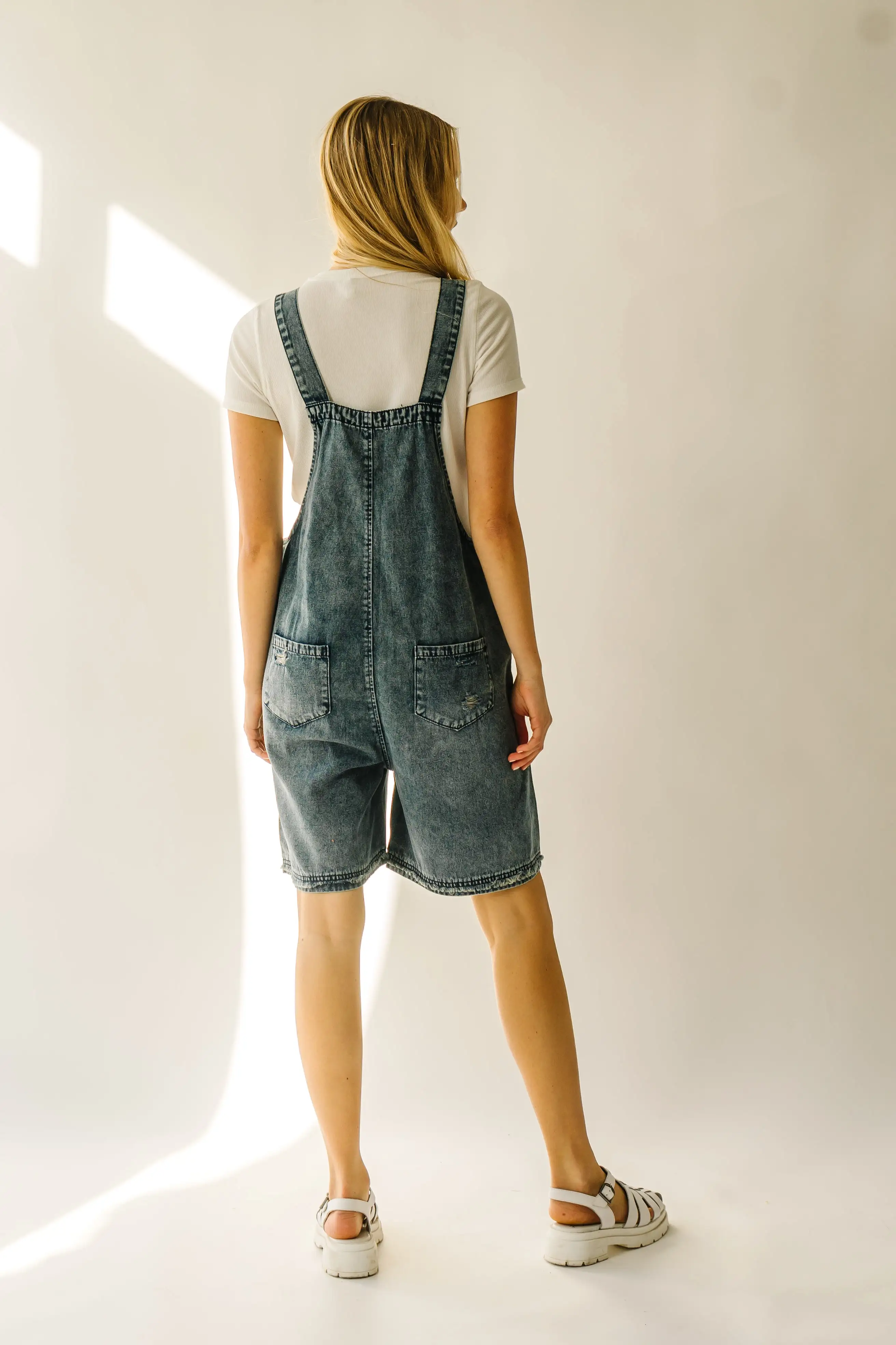 The Dearing Washed Denim Shorts Romper in Vintage Denim